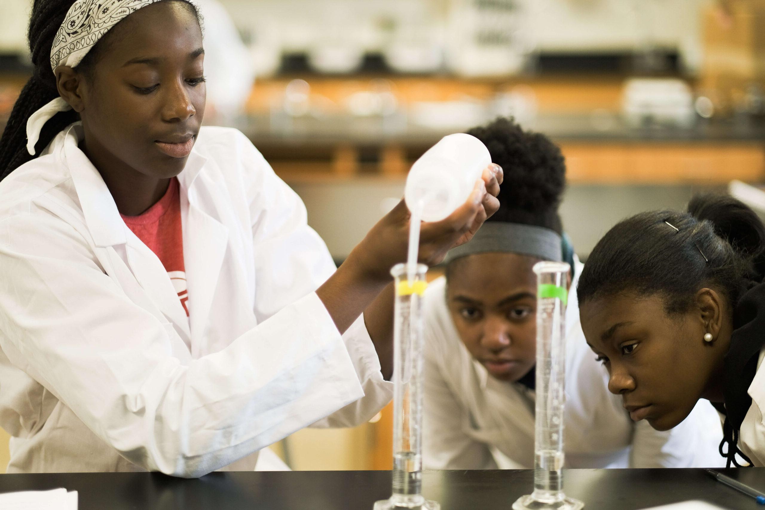college students focused on lab experiment